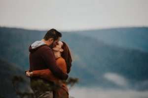 couple kissing at overlook in blackwater falls