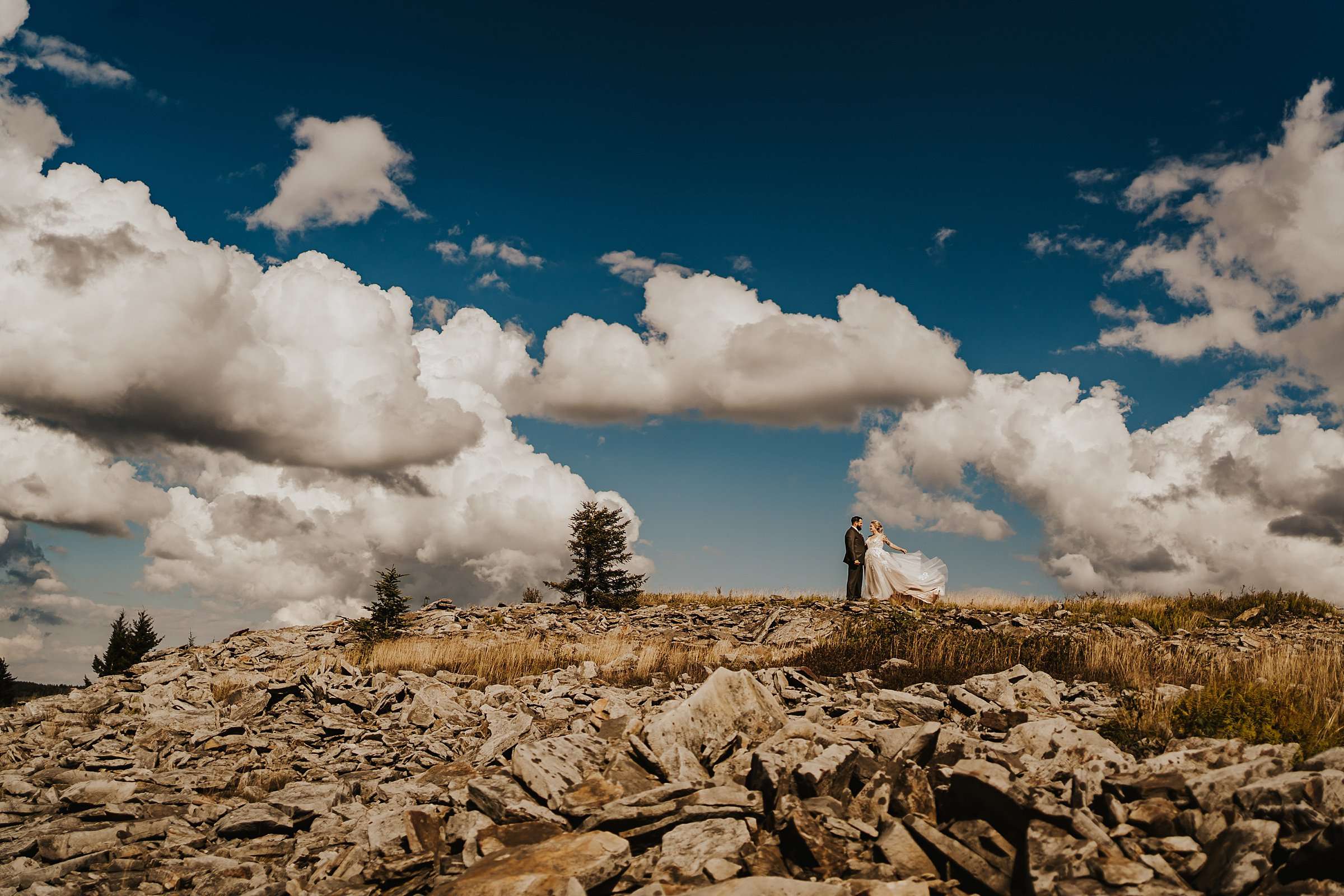 couple in dolly sods at elopement with dress flying