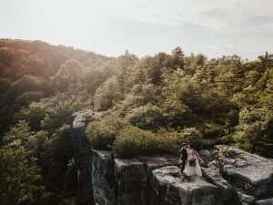 west virginia mountain elopement with couple standing at overlook and hugging