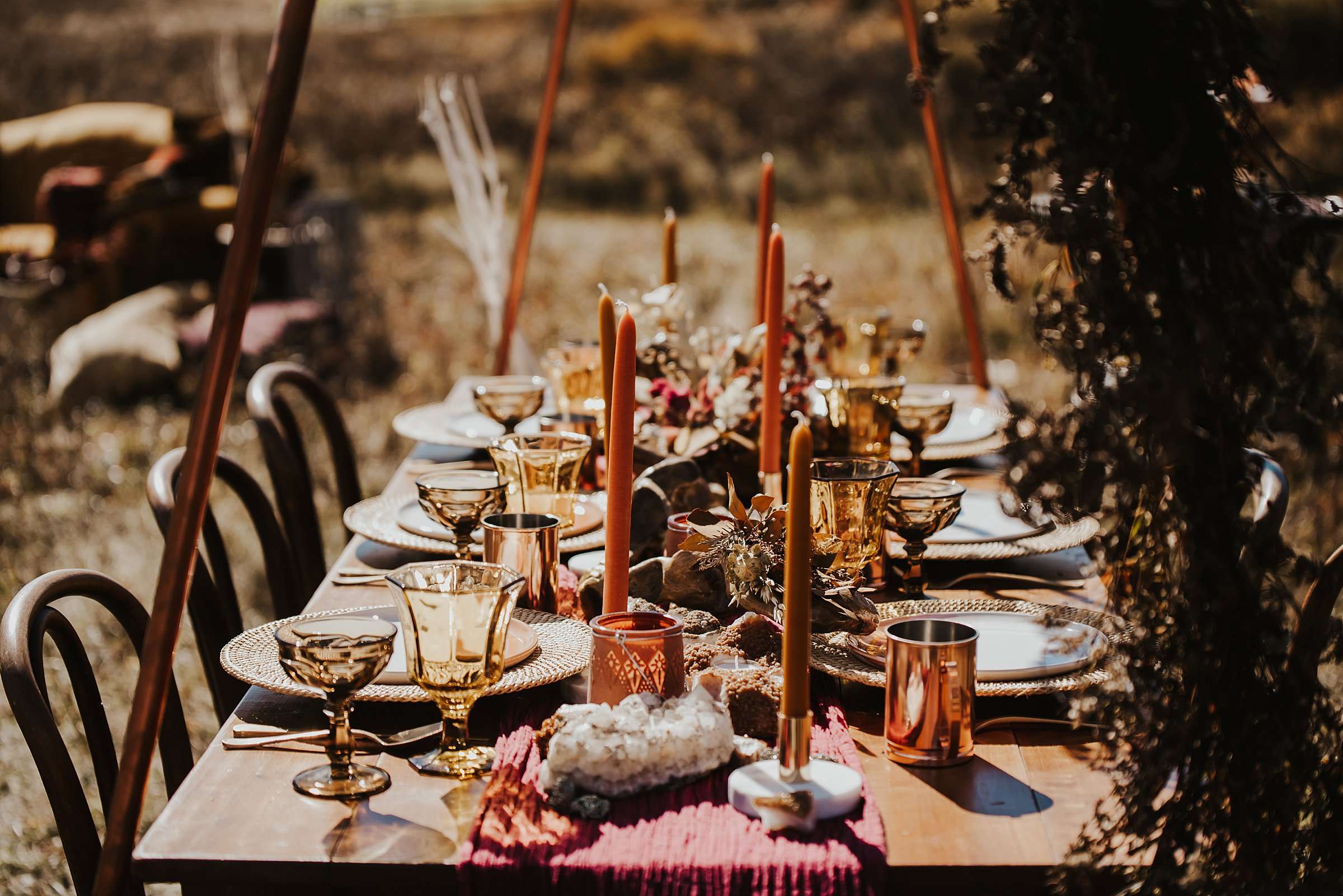 Tablescape with organe candles and brass mugs