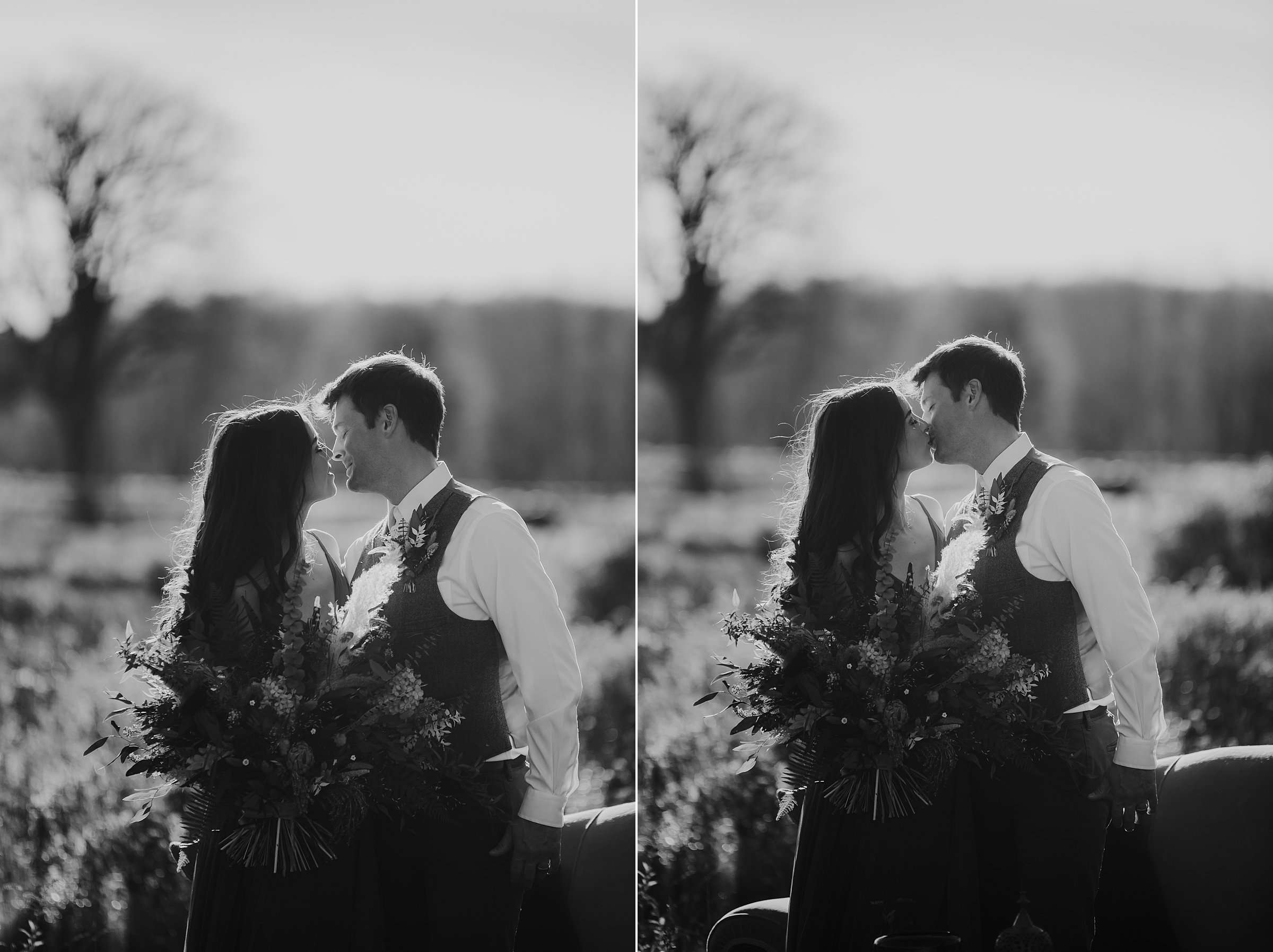 black and white image of couple kissing in boho clothing with dried bouquet