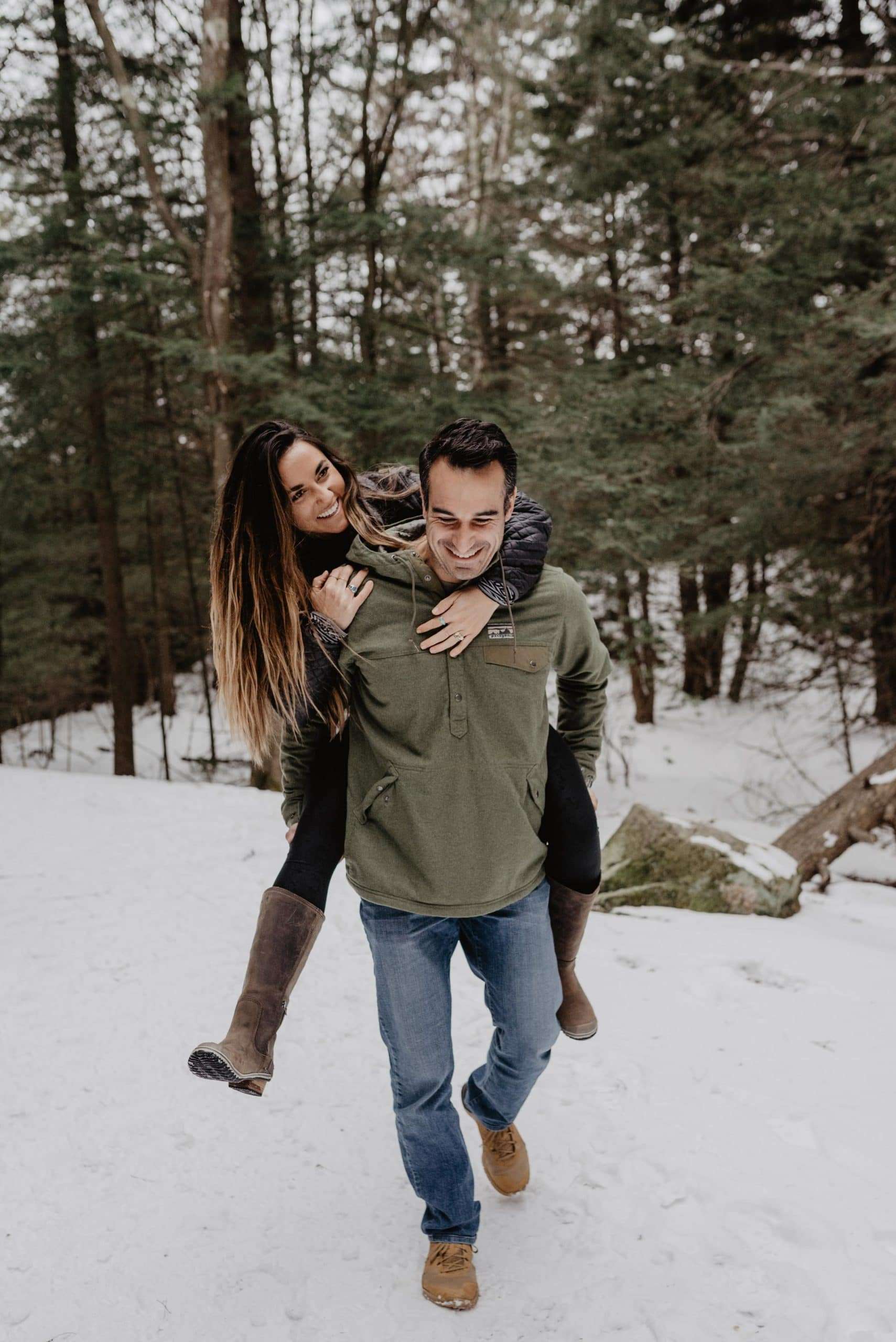 couple in snow giving piggyback at blackwater falls
